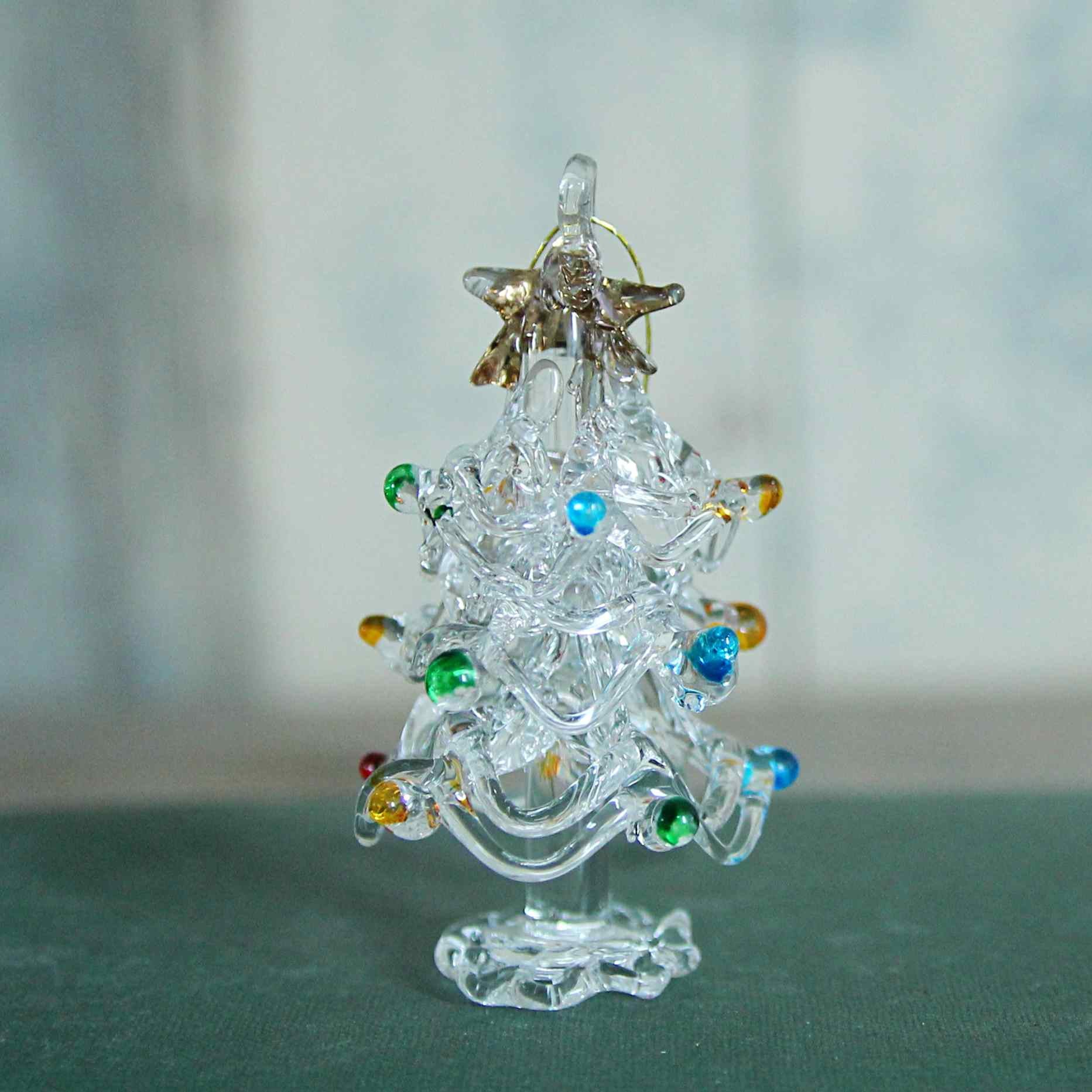 Tree decoration, made from hand blown glass featuring coloured glass baubles and a gold star on top